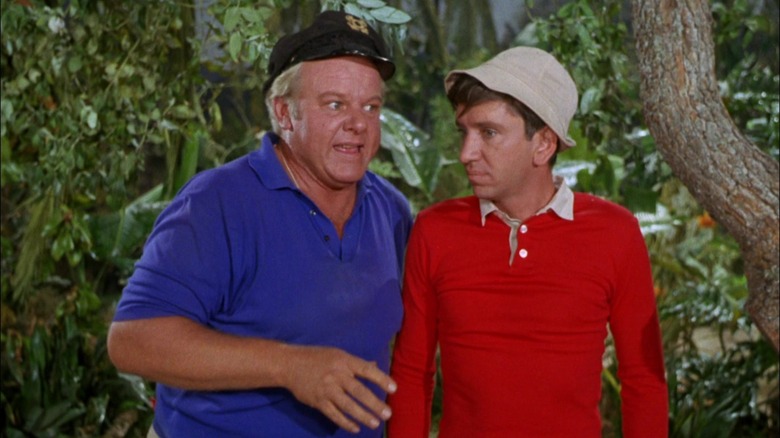 The Skipper and Gilligan standing next to the forest on Gilligan's Island.