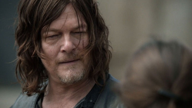 Norman Reedus's Daryl Dixon looks at someone off-screen in the 