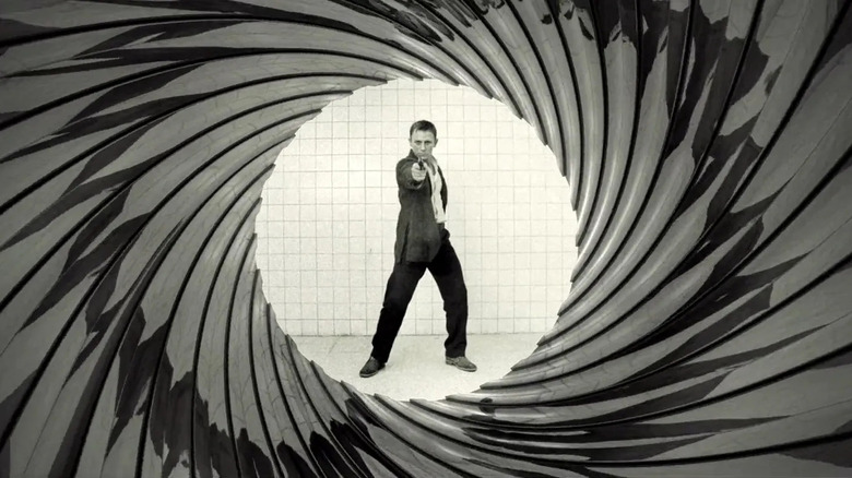 Daniel Craig's James Bond points his pistol toward camera in the gun barrel opening from Casino Royale