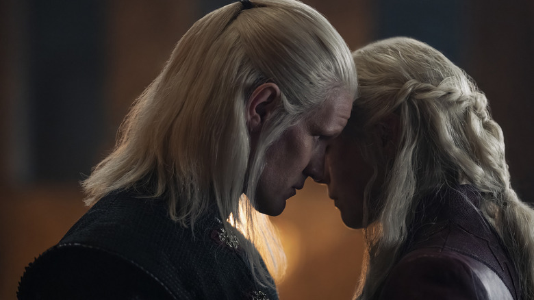 Rhaenyra and Daemon touching heads in House of the Dragon