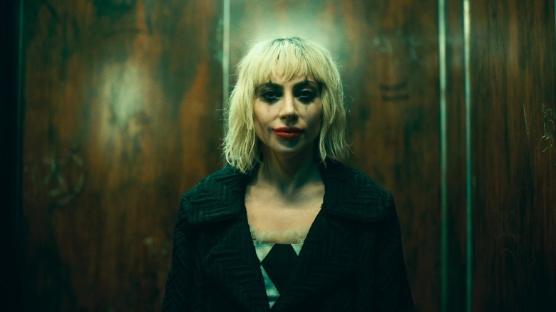 Lady Gaga's Harley Quinn wearing makeup and smiling in Joker: Folie a Deux