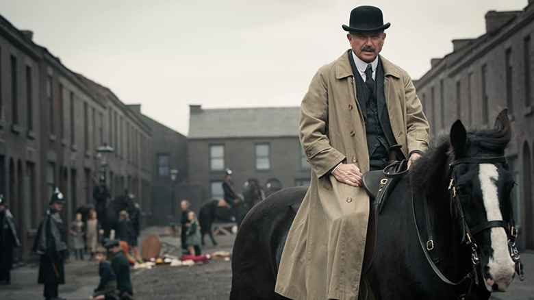 Sam Neill as Inspector Campbell riding a horse.