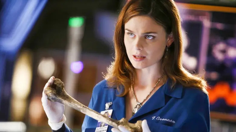 Temperance Brennan holding a human bone on Bones