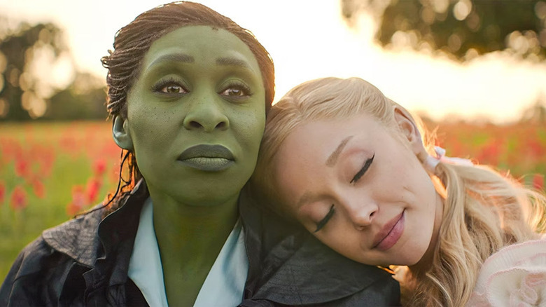 Ariana Grande as Galinda rests her head on the shoulder of Cynthia Erivo as Elphaba in Wicked