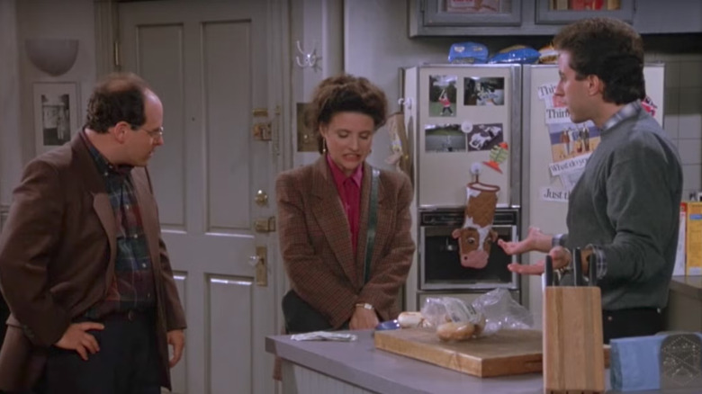 Jason Alexander as George, Julia Louis-Dreyfus as Elaine, and Jerry Seinfeld as Jerry talking on Seinfeld