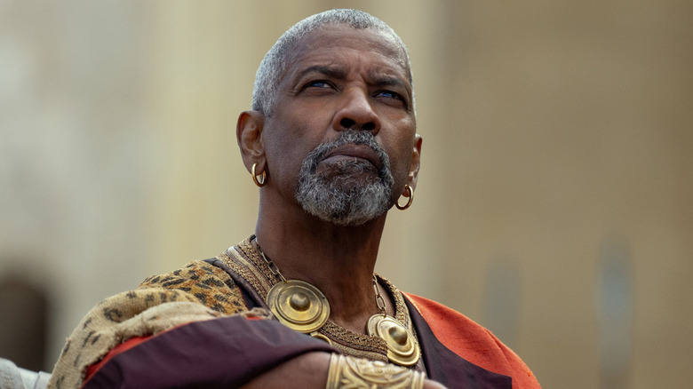 Denzel Washington as Macrinu, looking upwards, in Gladiator II