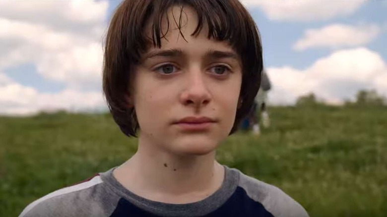 Noah Schnapp in grassy field Stranger Things