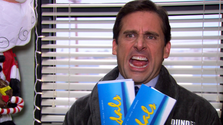 Michael Scott showing off his tickets to Jamaica in The Office 