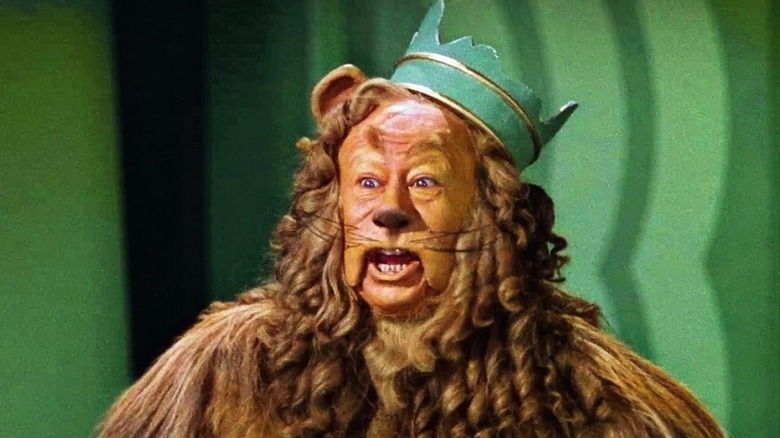 The Cowardly Lion wearing a hat and talking in The Wizard of Oz