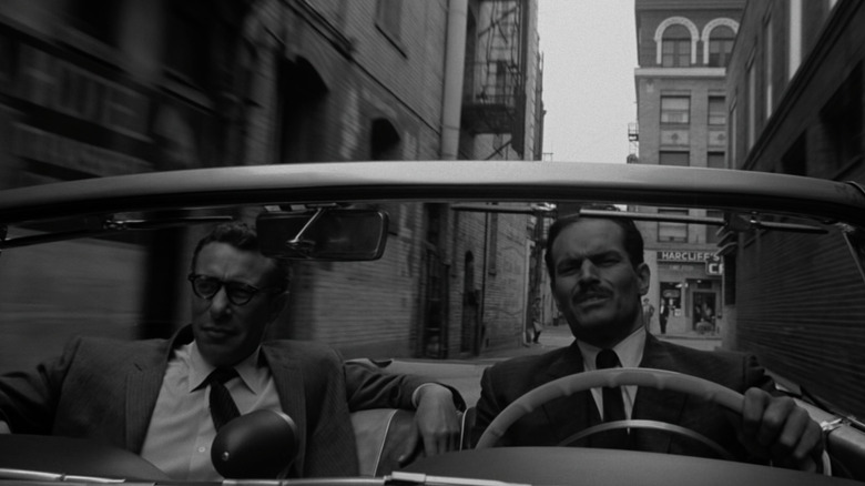 Mort Mills and Charlton Heston driving