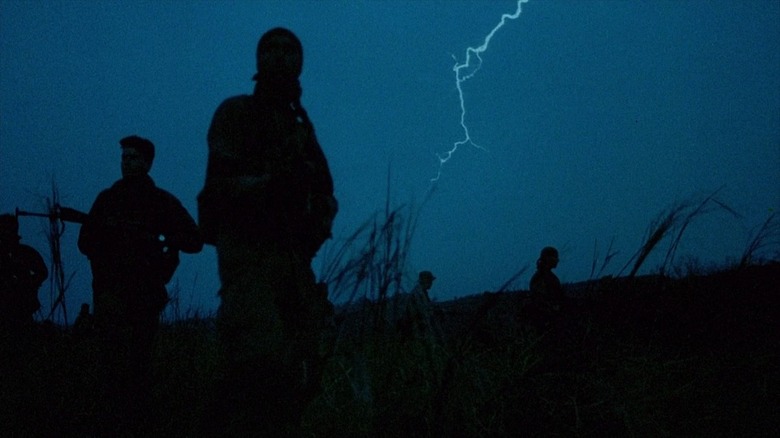 Platoon soldiers walking with lightning