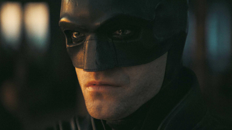 Robert Pattinson as Batman stares into the distance in The Batman