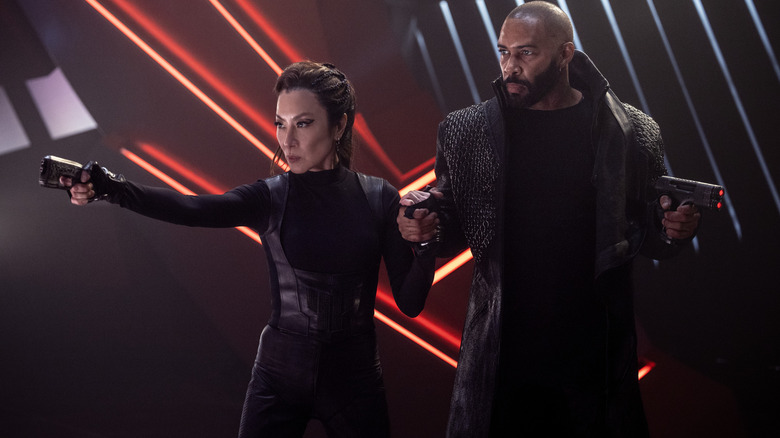 Michelle Yeoh as Philippa Georgiou and Omari Hardwick as Alok Sahar fending off enemies with their phasers in Star Trek: Section 31