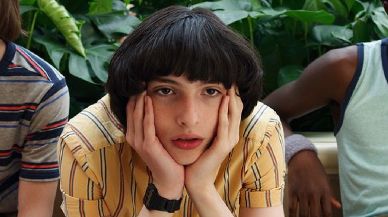 Finn Wolfhard head in hands in "Stranger Things"