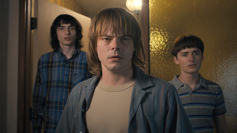 Charlie Heaton, Finn Wolfhard, and Noah Schapp stand guard in "Stranger Things" 