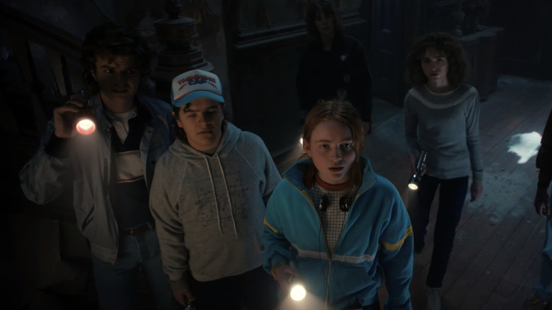 The gang in Stranger Things 4 with flashlights