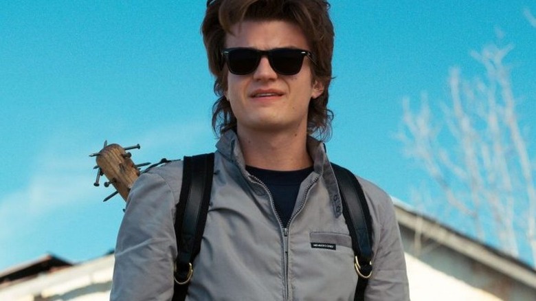 Steve Harrington with a weapon on his back in Stranger Things