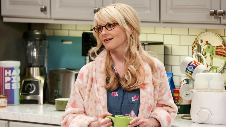 Bernadette in a pink robe drinking coffee on The Big Bang Theory