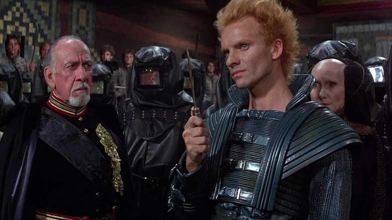 Feyd holding a knife, and the Emperor looking at him in Dune (1984)