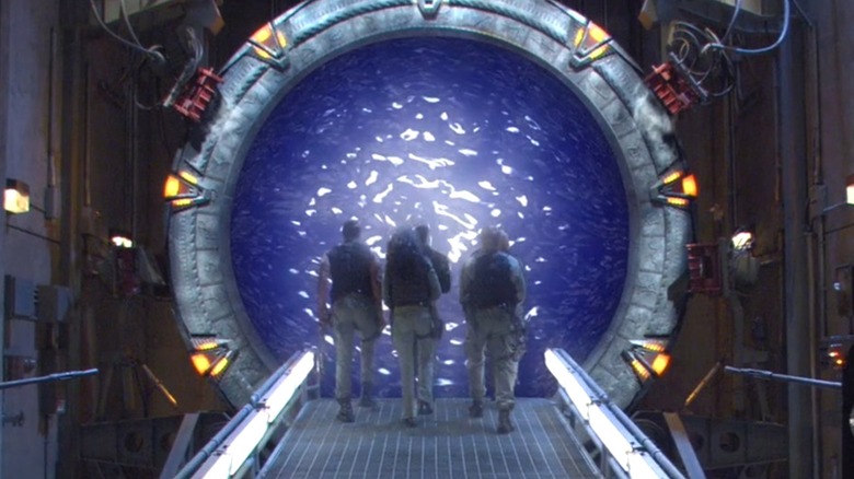 The SG-1 crew walking through a Stargate portal in Stargate SG-1