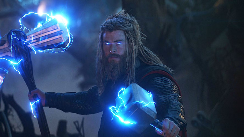 Thor wielding Stormbreaker and Mjolnir with glowing eyes in Avengers: Endgame