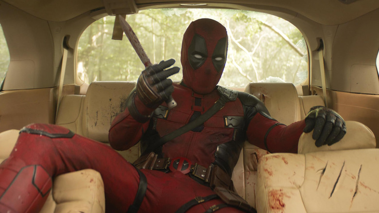 Deadpool taunting Wolverine with a knife in the Honda Odyssey