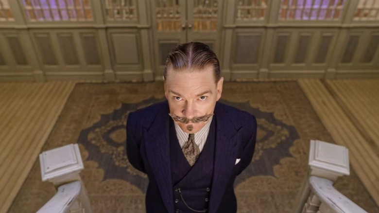 Hercule Poirot at the bottom of stairs in Death on the Nile