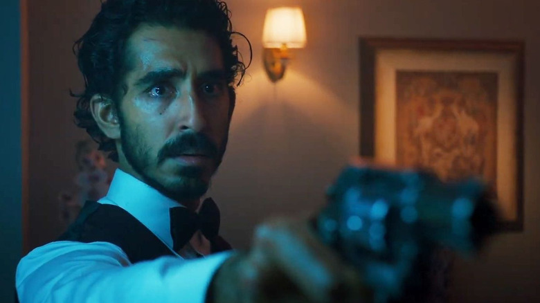 Dev Patel pointing a gun in Monkey Man