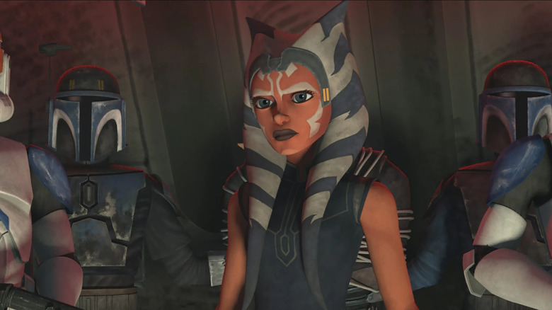 Ahsoka stands surrounded by clones and Mandalorians in The Clone Wars