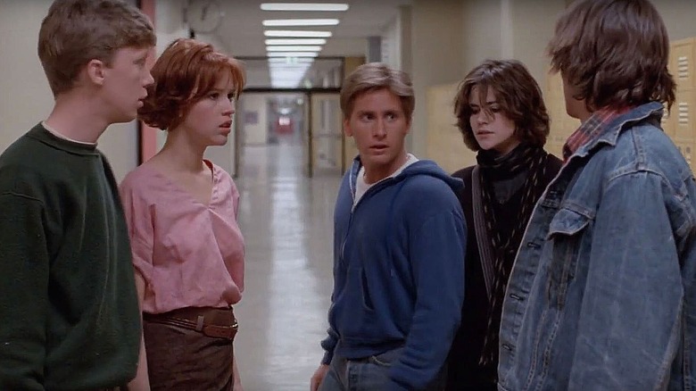 Five students stand in a school hallway in The Breakfast Club