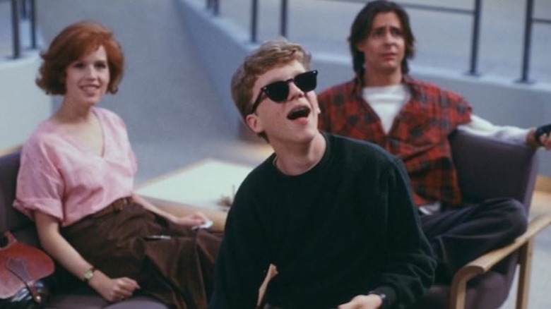 Brian looks up wearing sunglasses, with Claire and Bender behind him in The Breakfast Club