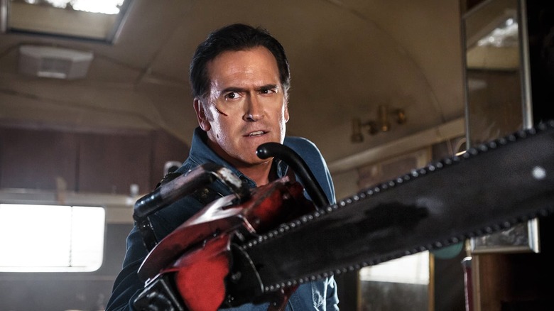 Ash in a trailer, wielding his chainsaw arm in Ash vs. Evil Dead.