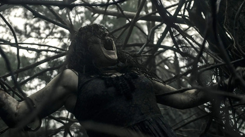 Mia being assaulted by demonic trees in the remake of Evil Dead.