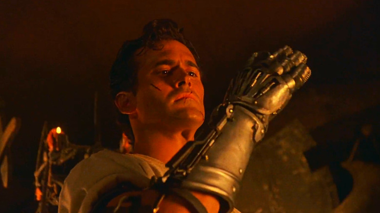 Ash, admiring his new metal hand in a scene from Army of Darkness.