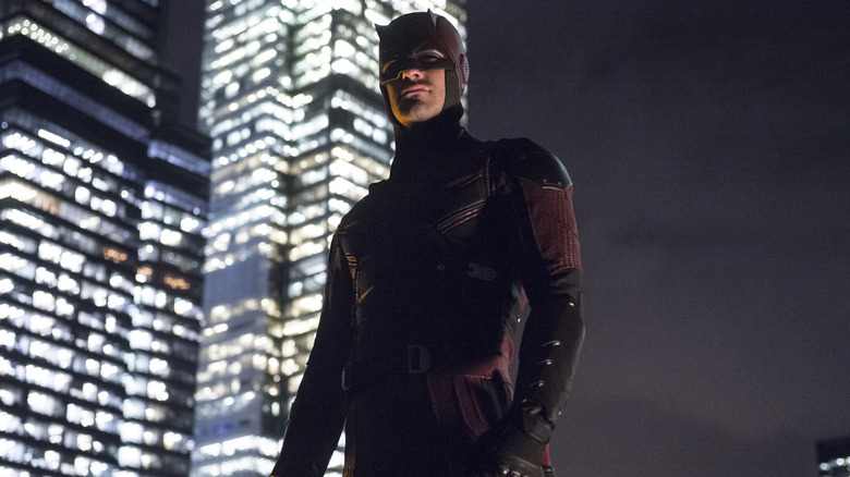 Dardevil standing in front of a skyscraper in Daredevil