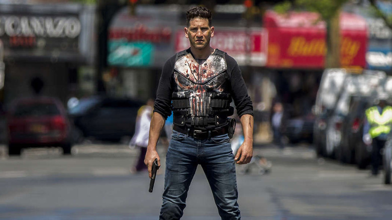 The Punisher in a bloody shirt and holding a gun on The Punisher