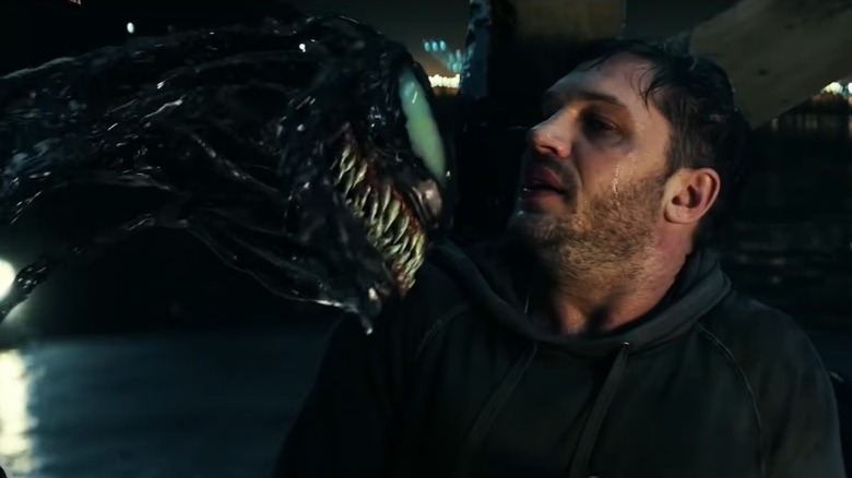 Eddie Brock being threatened by Venom in Venom