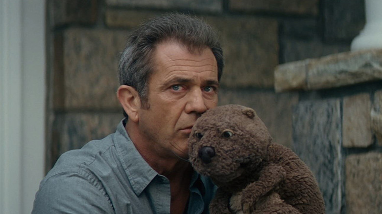 Mel Gibson as Walter Black speaks with a hand puppet in The Beaver