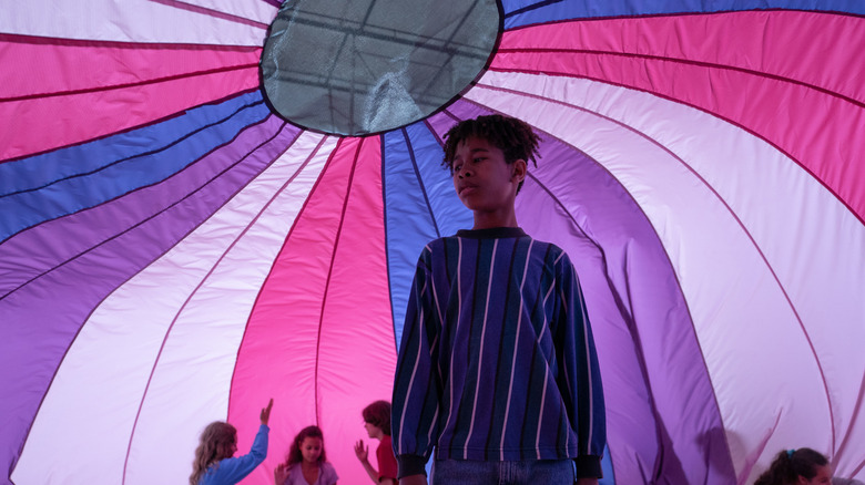 Young Owen standing under a parachute in the school gymnasium in I Saw the TV Glow