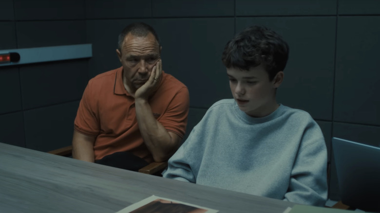 Stephen Graham's Eddie Miller sits besdie Owen Cooper's Jamie Miller in a police interrogation room in Adolescence