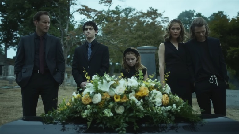 The Lambert family in cemetery by coffin