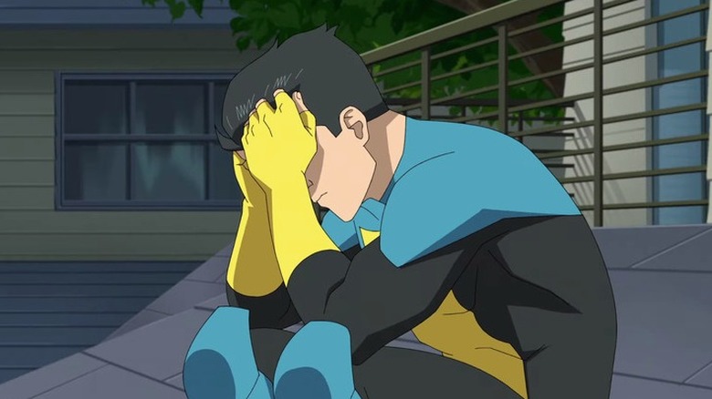 Mark Grayson/Invincible holding his head in his hands