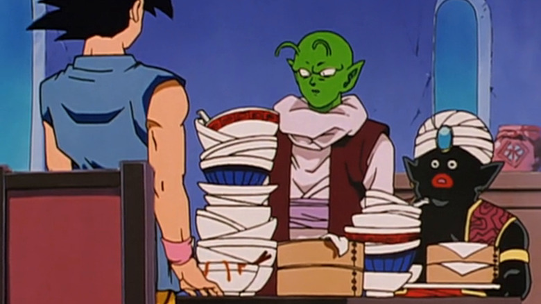 Gohan talks to Piccolo and Mr. Popo surrounded by dirty dishes in Dragon Ball GT