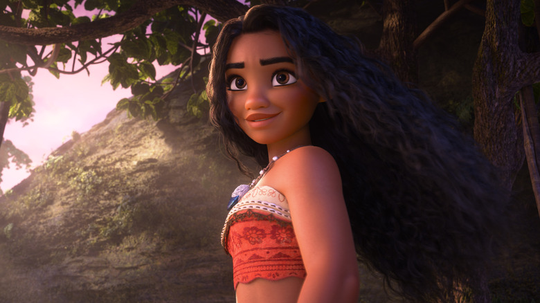 Moana stands smiling on an island in Moana 2