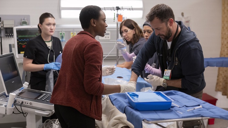 Isa Briones as Dr. Santos, Tracy Ifeachor as Dr. Heather Collins, and Noah Wyle as Dr. Michael Robinavitch on The Pitt