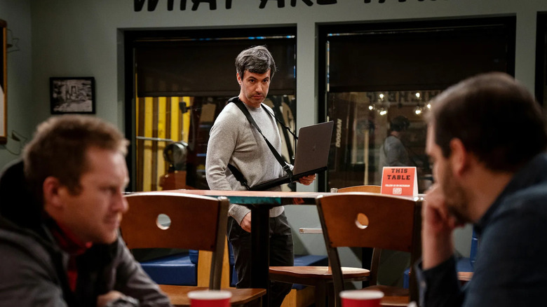 Nathan Fielder watching two people in The Rehearsal 