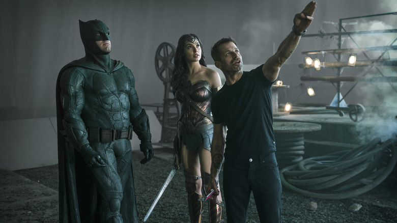 Zack Snyder on the set of "Justice League" directing Ben Affleck as Batman and Gal Gadot as Wonder Woman in a behind-the-scenes still