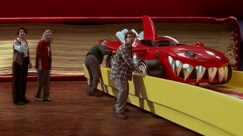 The cast of Honey We Shrunk Ourselves riding in a hot wheels car