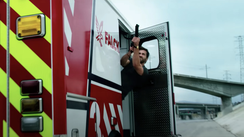 Jake Gyllenhaal hanging out of the ambulance