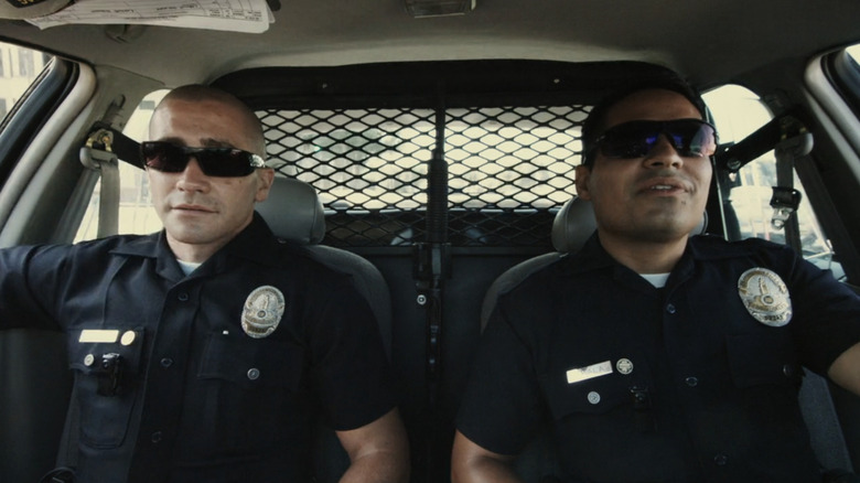 Jake Gyllenhaal's Brian Taylor and Michael Peña's Mike Zavala sit side by side in their police cruiser in End of Watch